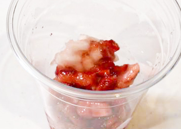 冷凍フルーツソース　ストロベリーをカップに注ぐ